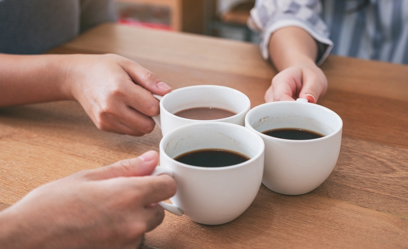 Hands around a coffee table